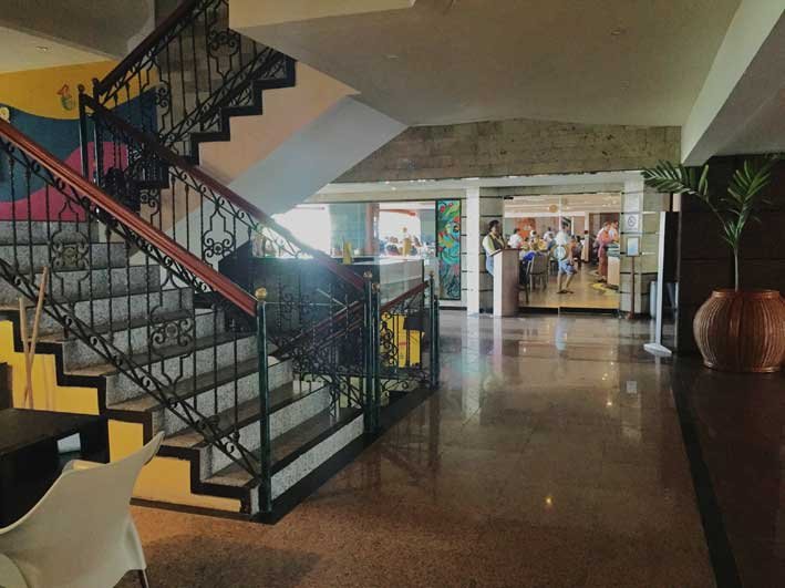 Ao lado dessa escada fica o balcão de turismo e lá ao fundo, a porte de vidro de acesso ao restaurante